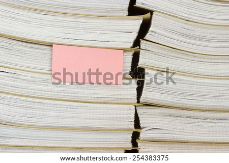 A pile of archival documents with blank bookmark