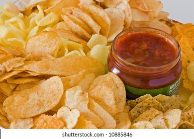 Pile Of Assorted Potato Chips With A Bottle Of Tasty Salsa Dip