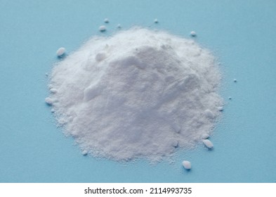 Pile Of Baking Soda On A Blue Background, Top View. Baking Soda, Sodium Bicarbonate, On A Blue Background, Top View. Baking Soda Powder, On A Blue Background, NaHCO3, Top View.