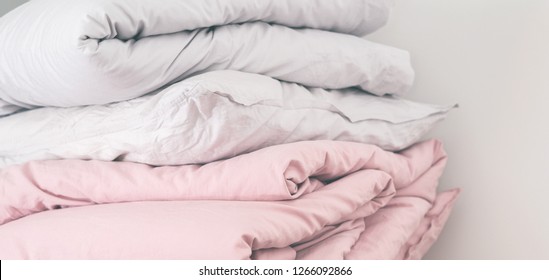 Сlose  up pile bed linen pillows blankets pink pastel colors  Long wide banner and copy space  cleaning Ironing service