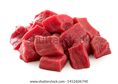 Pile of beef cubes isolated on white.