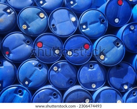 pile of blue plastic used drums 
