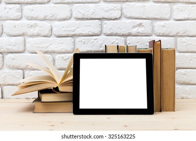 A Pile Of Books And Digital Tablet