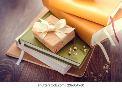 Pile of books on wooden background. Toned picture