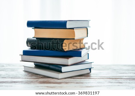 Pile of books on wooden table. Education and reading concept