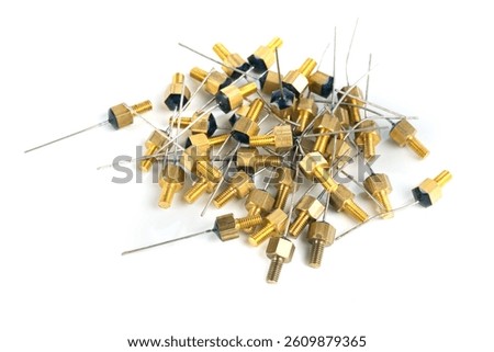 A pile of brass threaded electronic components with wire leads, isolated on a white background. Ideal for illustrating electronic parts, hardware, and engineering concepts.