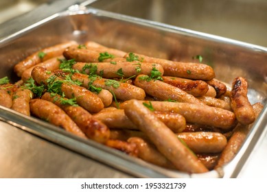 A Pile Of Breakfast Sausage With Herbs At A Buffet