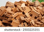 A pile of bricks is scattered on the ground. The bricks are of different sizes and shapes, and they are piled up in various ways. Concept of chaos and disarray