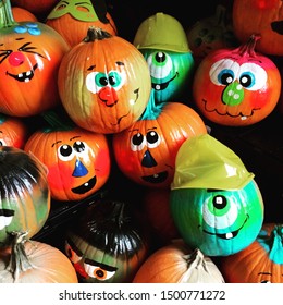 A Pile Of Brightly Decorated Pumpkins