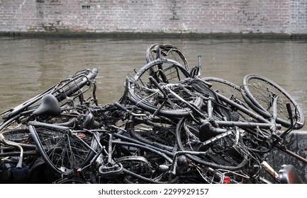 A pile of broken bicycles pulled from a canal on a barge in Amsterdam, Netherlands.