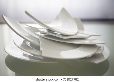 Pile Of Broken White Plates On Glass Table