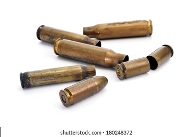 A Pile Of Bullets And Bullet Shells On A White Background