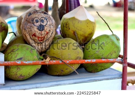 pile or bunch of coconuts on the cart, Tender coconut,  hawker selling coconut water
