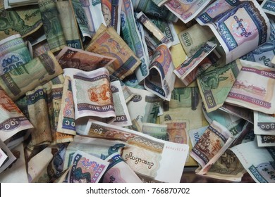 Pile Of Burmese Money In Donation Box