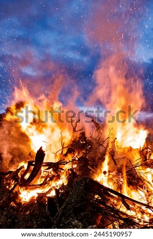 Pile of burning wood with spurts of fire