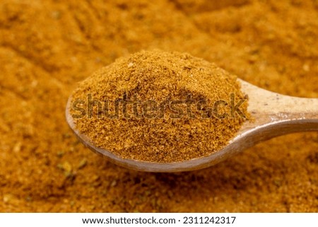 Pile of cajun powder as background, spice or seasoning as background. Close-up of cajun powder in wooden spoon