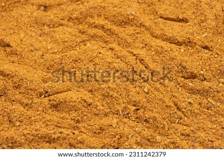 Pile of cajun powder as background, spice or seasoning as background. Close-up cajun powder
