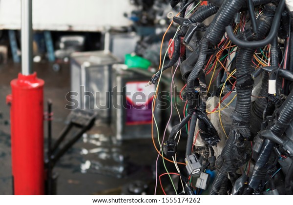 A pile of car wiring harness discarded in the\
garage. Background with copy\
space.
