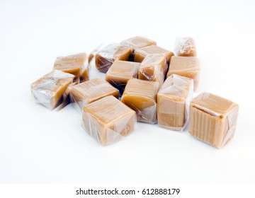 Pile Of Caramels Wrapped In Clear Cellophane. Isolated.