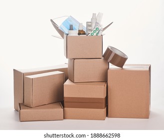 Pile Of Cardboard Boxes With Various Medicines And Adhesive Tape On White Background. Prescription Drugs Delivery Concept.