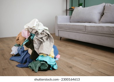 Pile of carelessly scattered clothes on floor.