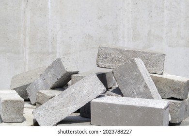 A pile of cement type bricks. Solid brick is used for construction. Lots of loose concrete bricks at the construction site - Shutterstock ID 2023788227