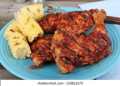 Pile Of Chicken Quarters And Corn On The Cob On A Platter