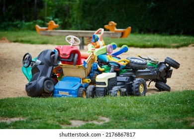 Pile Of Children's Toy Cars On A Playground