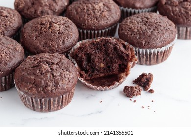Pile of chocolate muffins on a white background - Shutterstock ID 2141366501