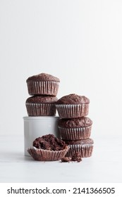 Pile of chocolate muffins on a white background - Shutterstock ID 2141366505