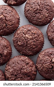 Pile of chocolate muffins on a white background - Shutterstock ID 2141366509