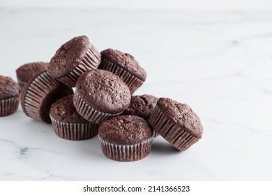 Pile of chocolate muffins on a white background - Powered by Shutterstock