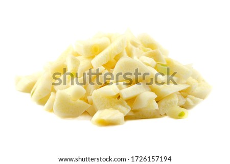 Pile of chopped garlic isolated on a white background. Finely chopped garlic on a white background. Sliced garlic cloves on a white background. Chopped garlic isolated on a white background.