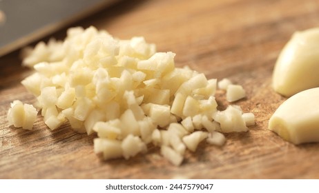 Pile of Chopping garlic on a cutting board. Fried Assassin's Spaghetti Cooking Step. Close-up, shallow dof.