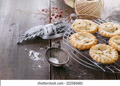 Pile Of Christmas Fruit Mince Pies And Christmas Decorations Over Rustic Wooden Background