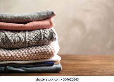 Pile of clothes on table - Shutterstock ID 564625645