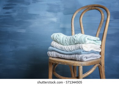 Pile Of Clothes On Wooden Chair