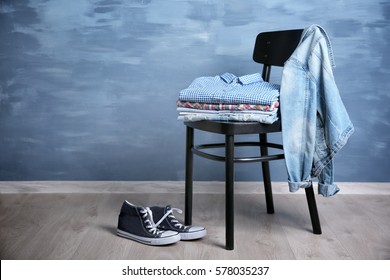 Pile Of Clothes On Wooden Chair