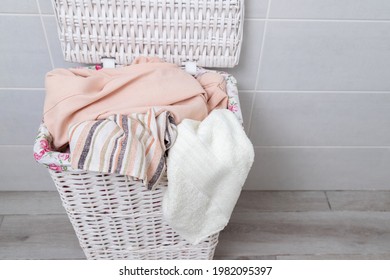 Pile Of Clothes In Wicker Laundry Basket. Top View