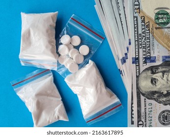 Pile Of Cocaine Flour And Pills On 100 Dollar Bills. Narcotic Drugs On American Money. Cocaine Abuse And Criminal Business.