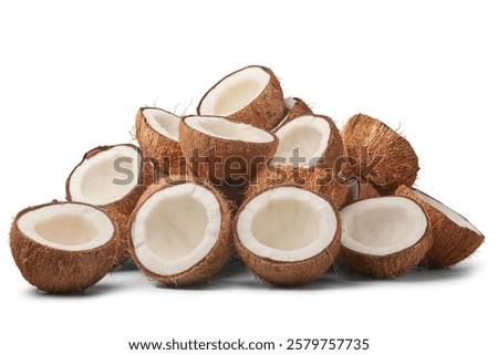 pile of coconuts cut in half isolated white background, brown fibrous husk and inner white flesh visible, abundance and freshness concept