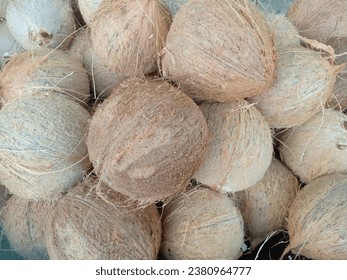 pile of coconuts that have been peeled from the outer shell - Shutterstock ID 2380964777