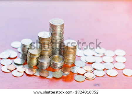 A pile of coin savings concept on wood background.