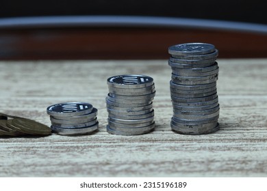 Pile of coins on the table. Financial and business concept. - Shutterstock ID 2315196189