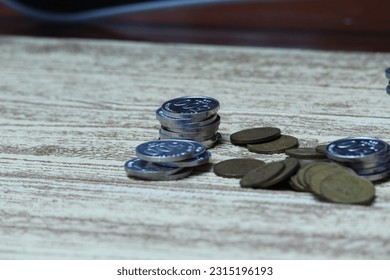 Pile of coins on the table. Financial and business concept. - Shutterstock ID 2315196193