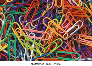 Pile Of Colored Paper Clips Over Black Background