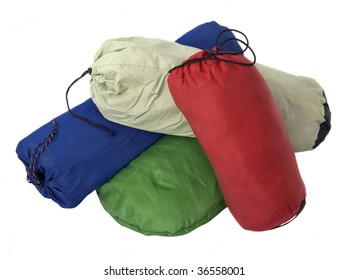 A Pile Of Colorful Bags With Camping Equipment (tent, Sleeping Bag, Pad) Isolated On White