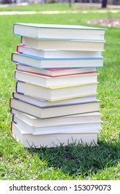 A Pile Of Colorful Books On Lawn In Campus 