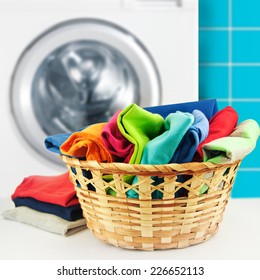 Pile Of Colorful Clean Clothes With Washing Machine.