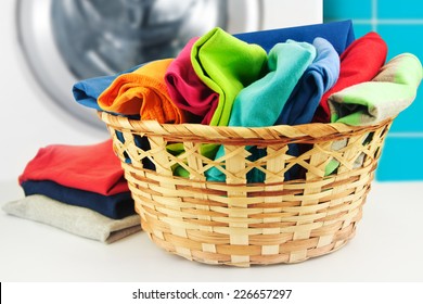 Pile Of Colorful Clean Clothes With Washing Machine.